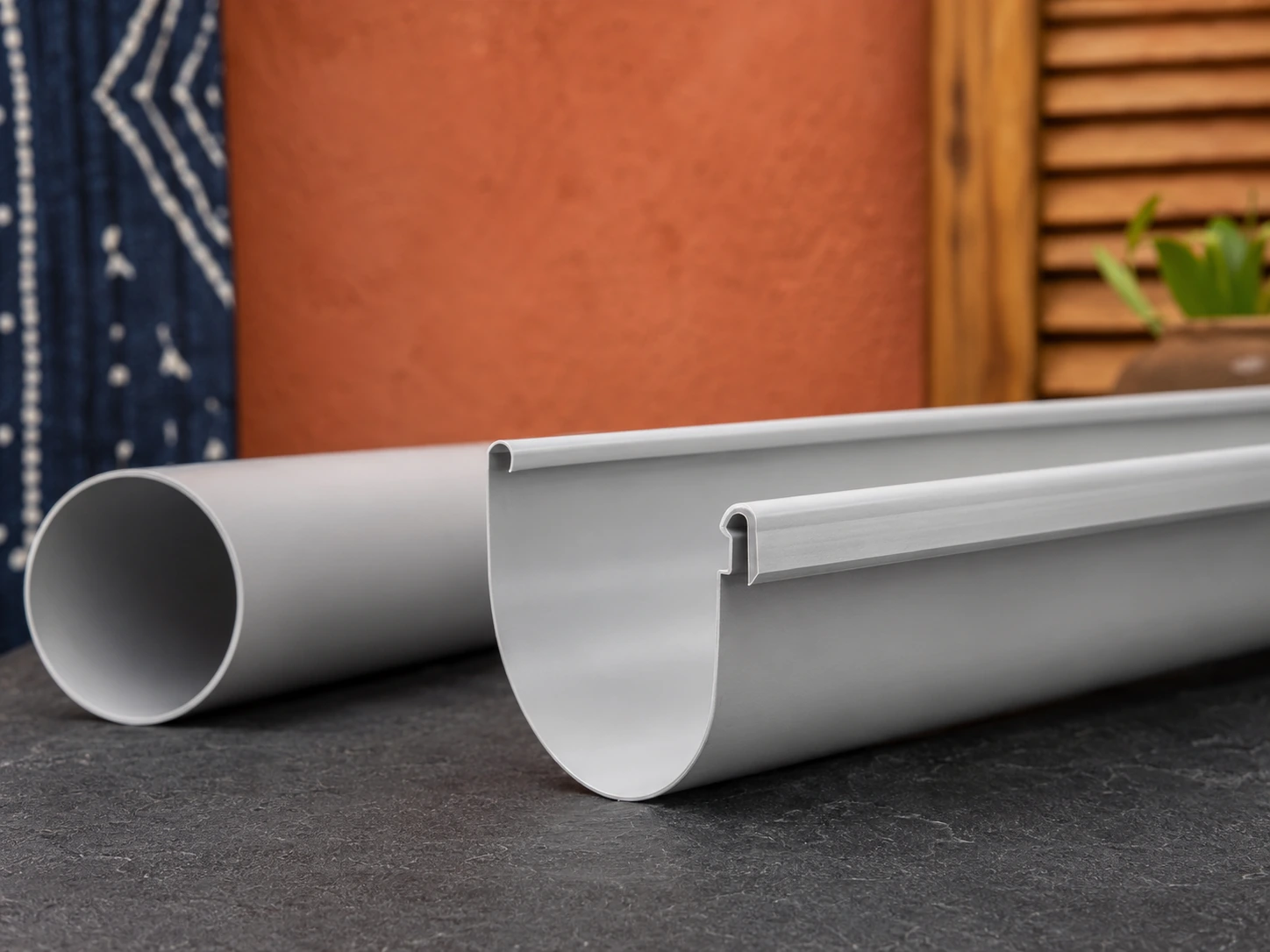 Close-up of gutter profile and pipe opening